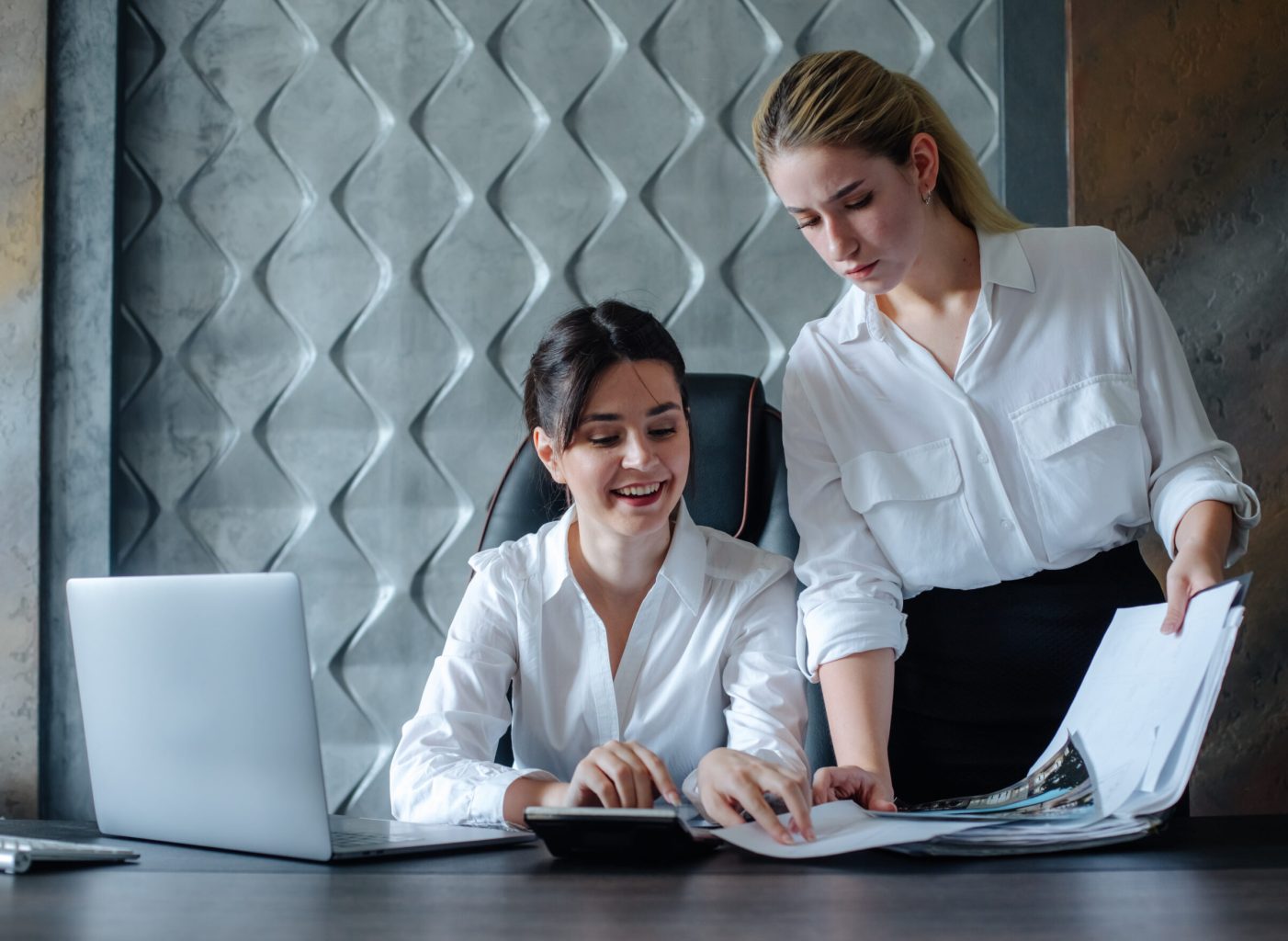 young business lady female director sitting at office desk working process business meeting working with colleague solving business tasks office collective concept
